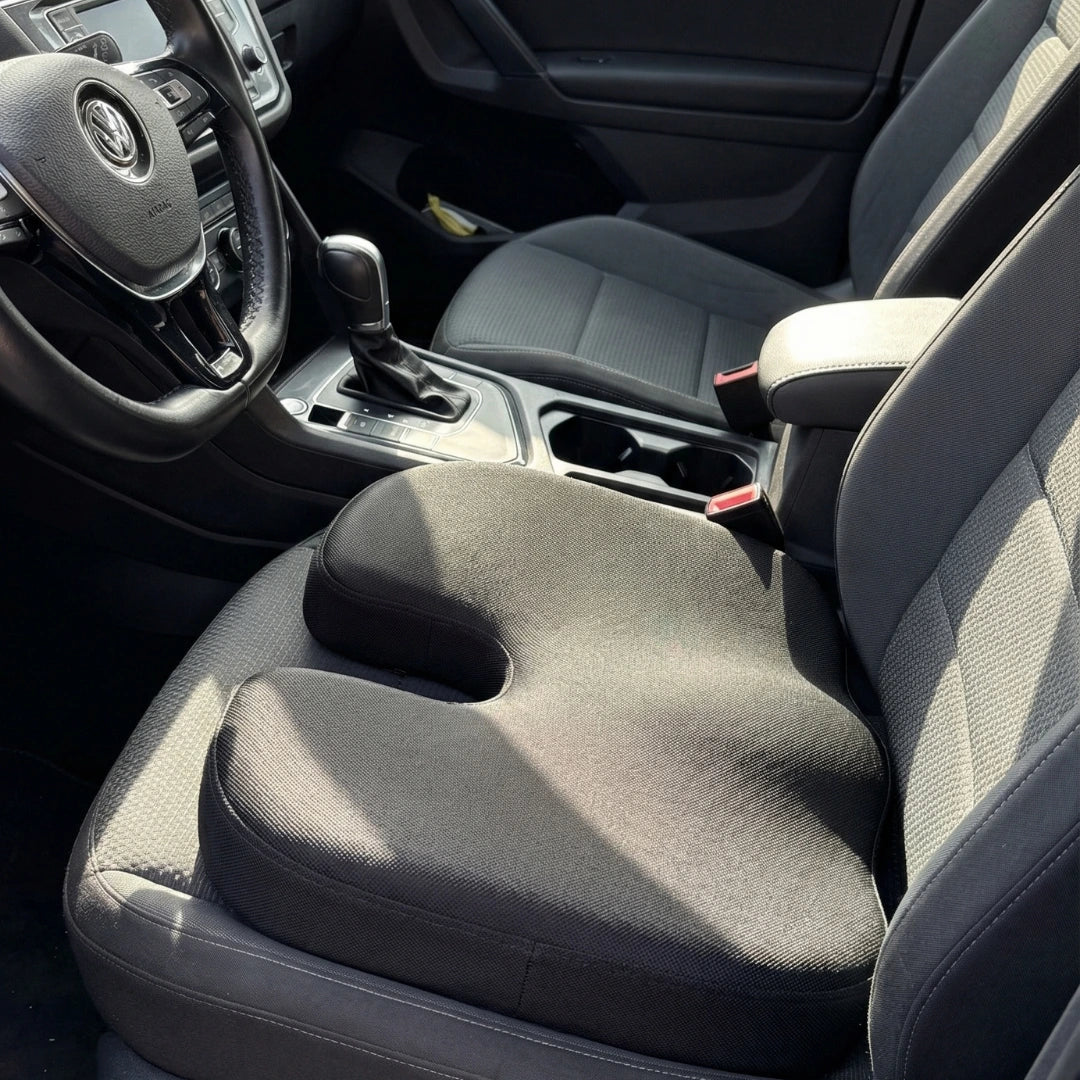 Car interior with a gray seat cushion on the driver's seat